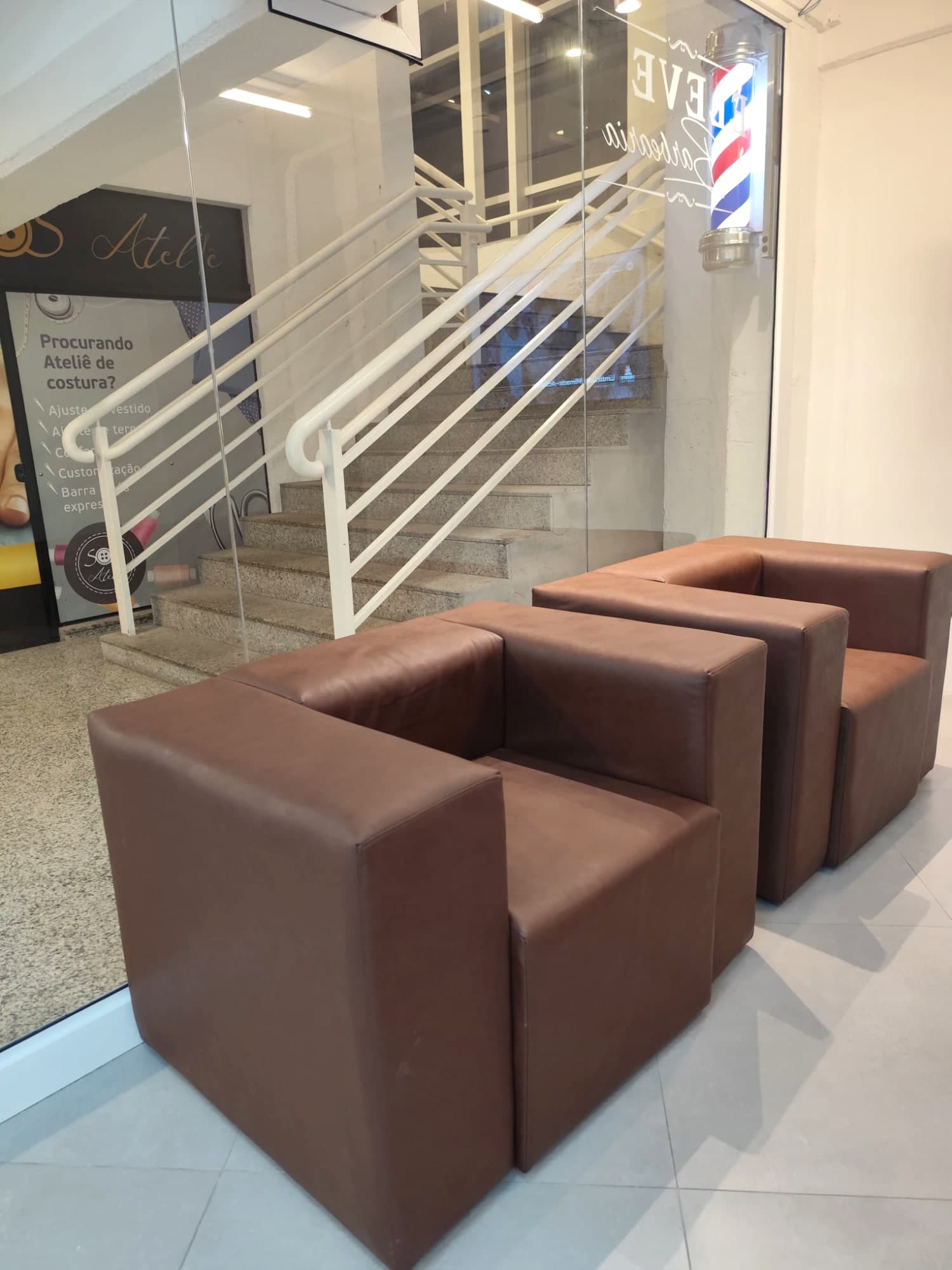 Entrada de vidro da Eleve Barbearia com a marca aplicada