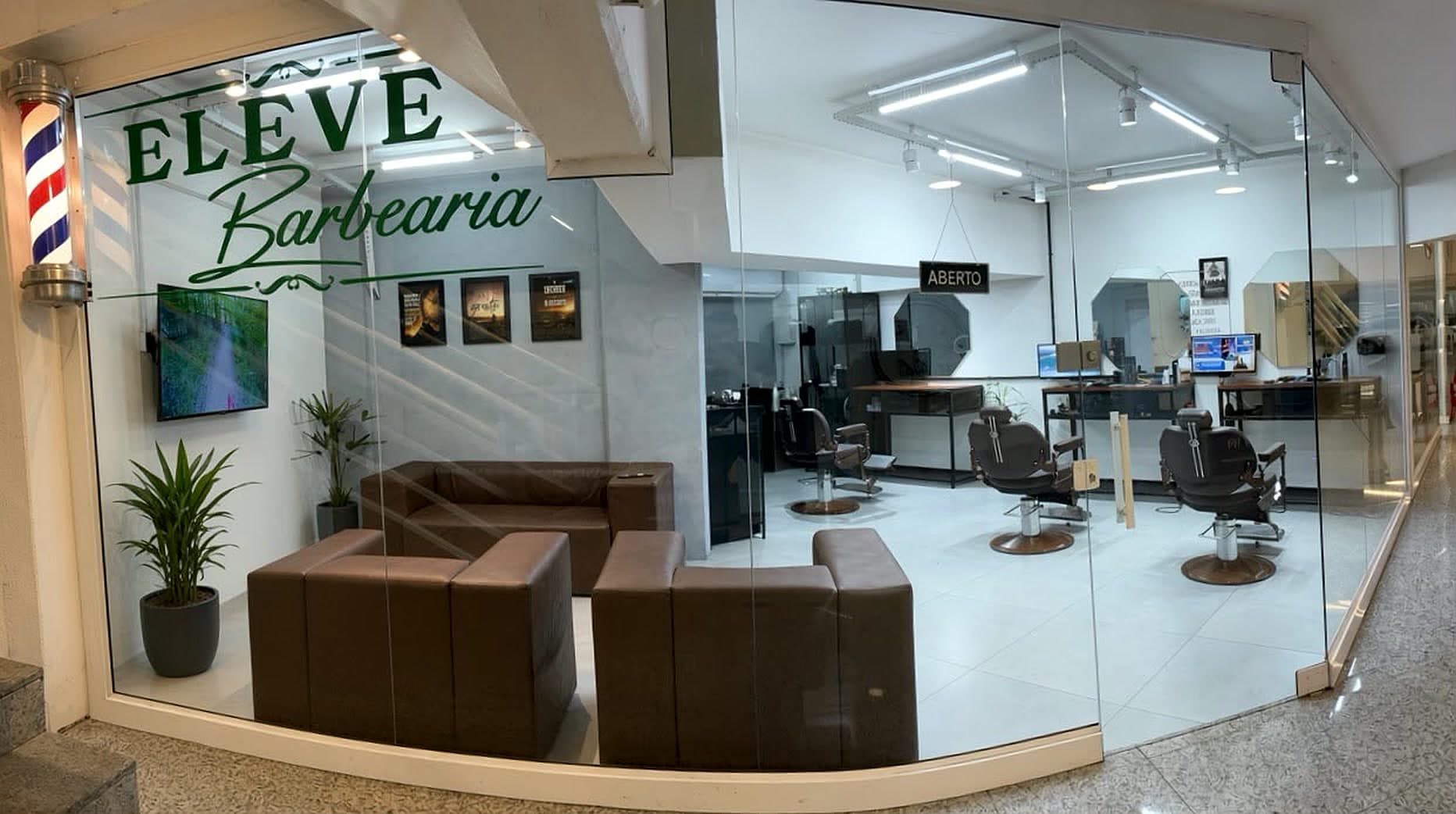 Fachada de vidro da Eleve Barbearia no Itajaí Shopping, com a logo aplicada e o salão ao fundo